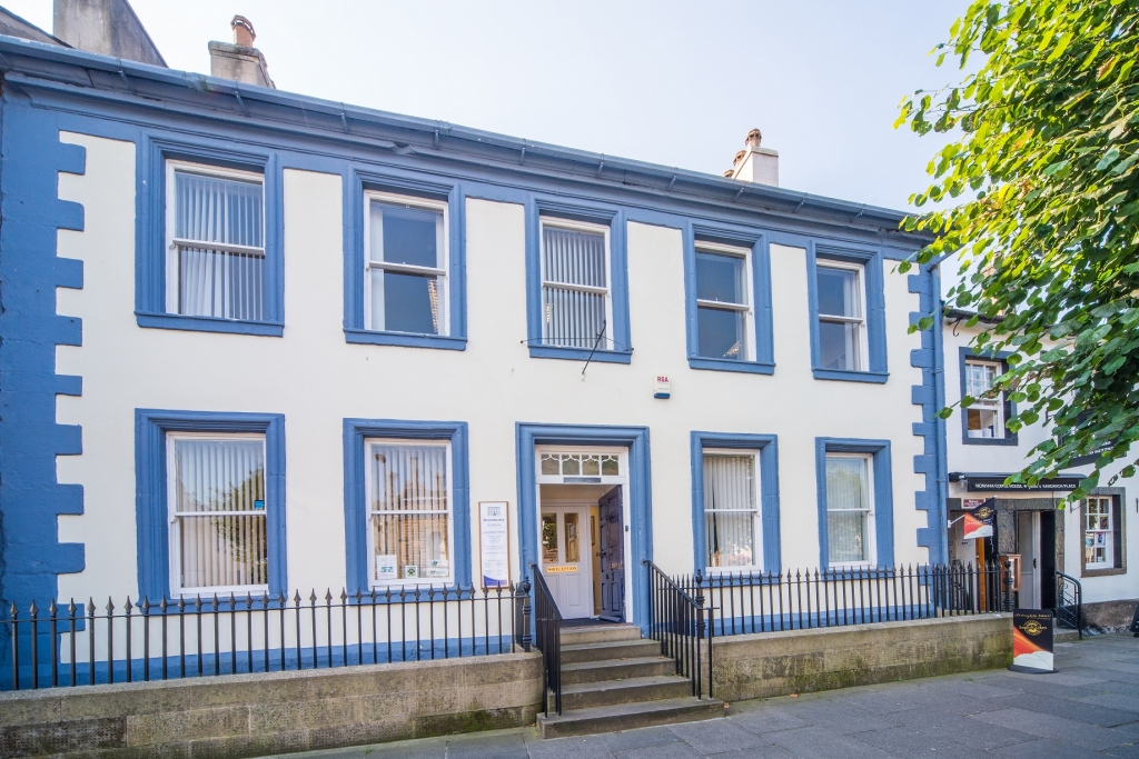 Brockbanks Solicitors' Cockermouth office — a white townhouse with blue-painted stonework