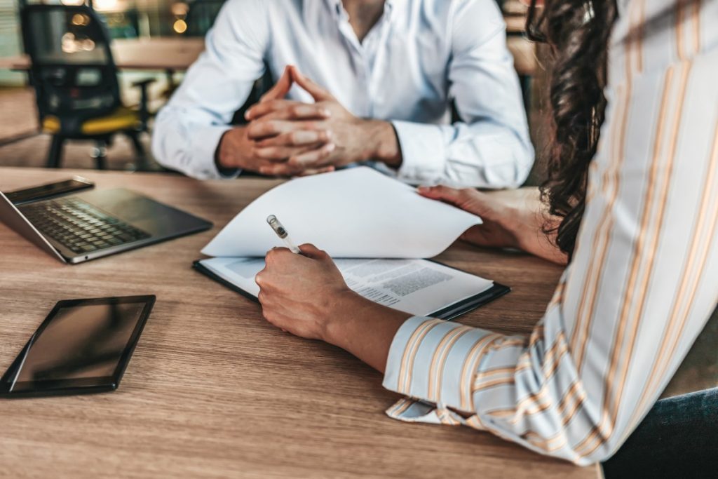 A solicitor and a client reviewing a document together across a desk